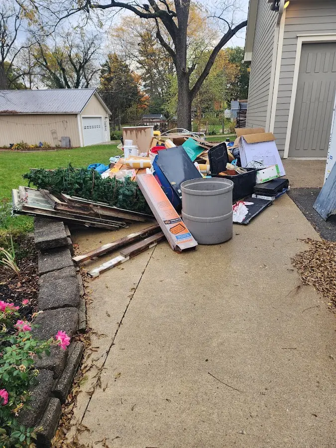 Dumpster being loaded with debris for Estate Cleanout Dumpster Rental in Mount Holly